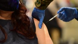 PHILADELPHIA, PA - MARCH 02: A member of the U.S. Armed Forces administers a COVID-19 vaccine at a FEMA community vaccination center on March 2, 2021 in Philadelphia, Pennsylvania. Located at the Pennsylvania Convention Center, the site is being run as a partnership between the city and the federal government. It is part of a nearly $4 billion plan for FEMA to support more than 400 community vaccination centers across the country.  (Photo by Mark Makela/Getty Images)