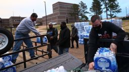 JACKSON, MISSISSIPPI - MARCH 05: Packages of bottled water brought from the Onondaga Nation Reservation in Western New York are unloaded at a water distribution site in the parking lot of Forest Hill High School on March 05, 2021 in Jackson, Mississippi. Residents in parts of Jackson, Mississippi, where 80% of the residents are Black, have been without running water since mid February after the city was hit by back-to-back winter storms. The storms damaged the city's already crumbling infrastructure and left residents without access to running water. A citywide boil notice remains in effect since February 14, when Mississippi Governor Reeves and Lieutenant Governor Delbert Hosemann declared a state of emergency. (Photo by Michael M. Santiago/Getty Images)