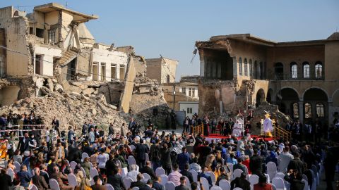 People attend a prayer led by Pope Francis for war victims at the Church Square in Mosul's Old City.