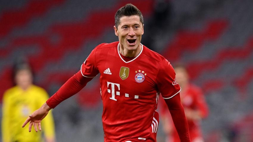 MUNICH, GERMANY - MARCH 06: Robert Lewandowski of FC Bayern Muenchen celebrates after scoring their side's fourth goal, completing his hat-trick during the Bundesliga match between FC Bayern Muenchen and Borussia Dortmund at Allianz Arena on March 06, 2021 in Munich, Germany. Sporting stadiums around Germany remain under strict restrictions due to the Coronavirus Pandemic as Government social distancing laws prohibit fans inside venues resulting in games being played behind closed doors. (Photo by Sebastian Widmann/Getty Images)