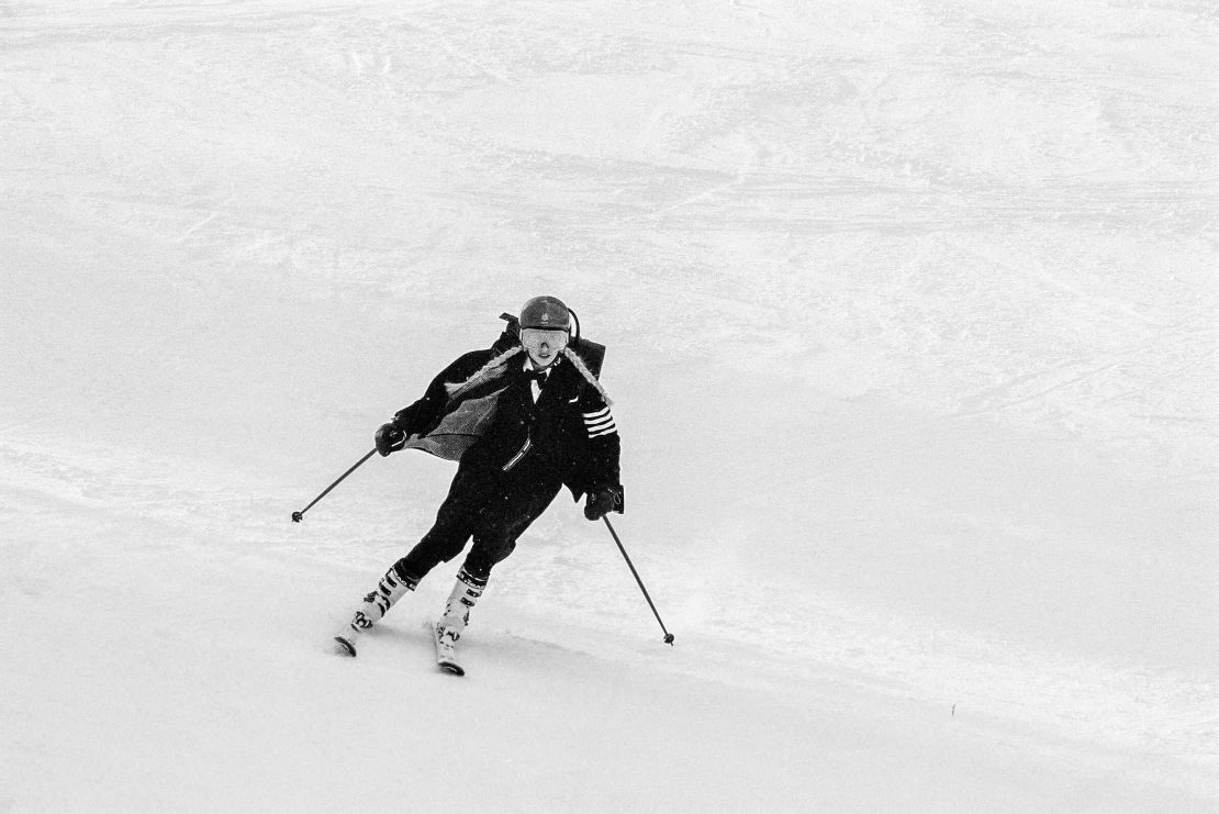 Vonn dressed in Thom Browne, skiing down a slope. 