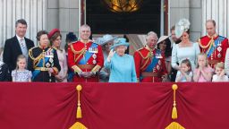 Members of the Royal Family (L-R) Vice Admiral Timothy Laurence, Britain's Princess Anne, Princess Royal, Britain's Princess Beatrice of York, Britain's Prince Andrew, Duke of York, Britain's Camilla, Duchess of Cornwall, Britain's Queen Elizabeth II, Britain's Prince Charles, Prince of Wales, Britain's Meghan, Duchess of Sussex, Britain's Prince Harry, Duke of Sussex, Britain's Catherine, Duchess of Cambridge (with Princess Charlotte and Prince George) and Britain's Prince William, Duke of Cambridge, stand on the balcony of Buckingham Palace to watch a fly-past of aircraft by the Royal Air Force, in London on June 9, 2018. - The ceremony of Trooping the Colour is believed to have first been performed during the reign of King Charles II. In 1748, it was decided that the parade would be used to mark the official birthday of the Sovereign. More than 600 guardsmen and cavalry make up the parade, a celebration of the Sovereign's official birthday, although the Queen's actual birthday is on 21 April. 
