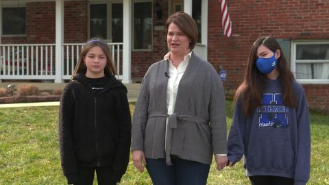 Sixth-graders Elizabeth (left) and Katharine Porter are split about whether to return to classrooms, their mother Jennfer says.