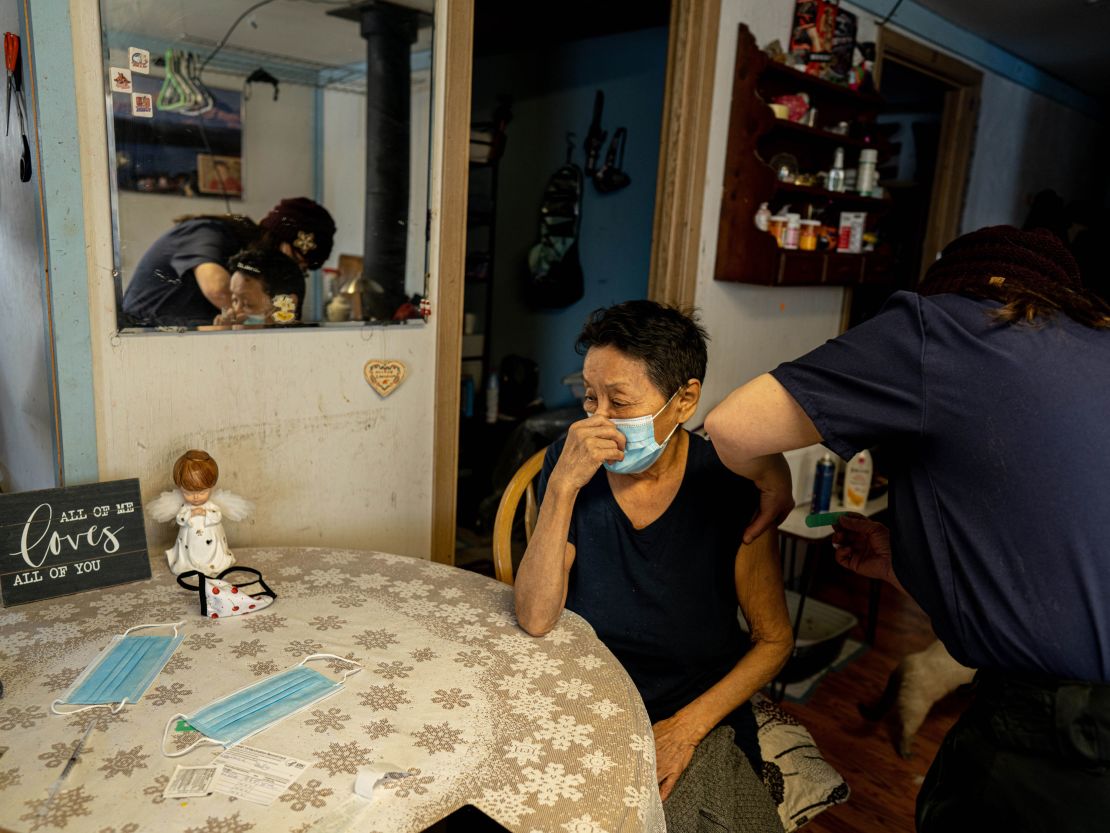 Debra McCarty, the director of the medical clinic in Fort Yukon, Alaska, administers a COVID-19 vaccine in February. Sovereign tribes received their own vaccine allocations through the Indian Health Service.