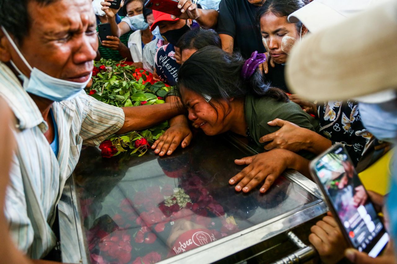 The wife of Phoe Chit, a protester who died during a demonstration, cries over her husband's coffin during his funeral in Yangon on March 5.