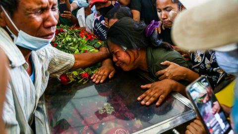 The wife of Phoe Chit, a protester who died during a demonstration against the military coup on March 3, cries over the coffin of her husband during his funeral in Yangon on March 5.