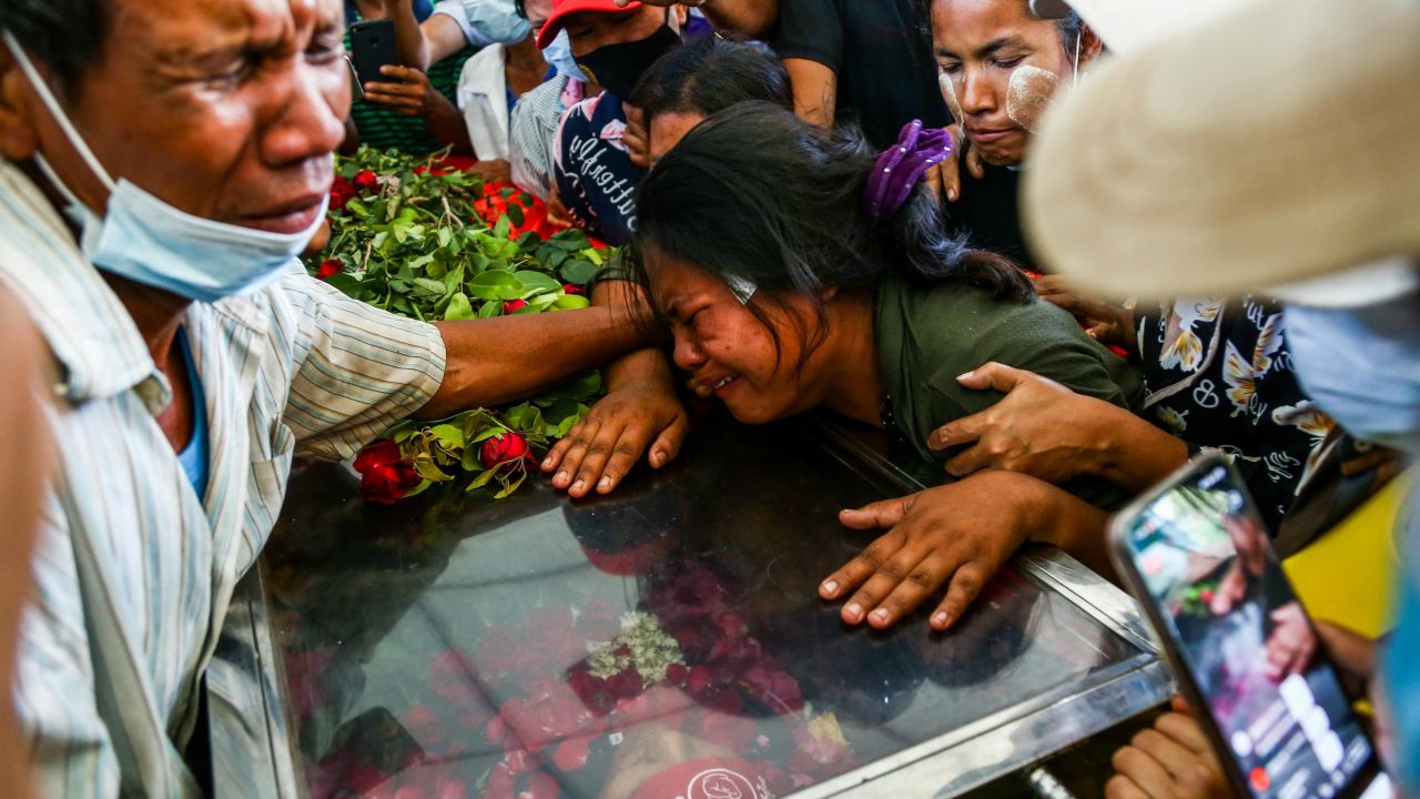 The wife of Phoe Chit, a protester who died during a demonstration against the military coup on March 3, cries over the coffin of her husband during his funeral in Yangon on March 5.