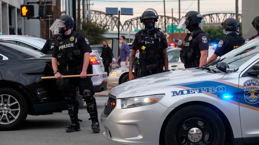 Police officers block an intersection on a third day of protest over the lack of criminal charges in the police killing of Breonna Taylor and the result of a grand jury inquiry, in Louisville, Kentucky, on September 25, 2020. - The family of Breonna Taylor today, September 25, demanded that US authorities release grand jury transcripts showing why no police will face direct criminal charges over her death, which has once again galvanized protesters angry about racism and police brutality in America. (Photo by Jeff Dean / AFP) (Photo by JEFF DEAN/AFP via Getty Images)