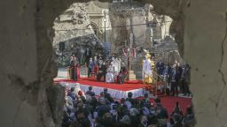 Pope Francis, surrounded by shells of destroyed churches, attends a prayer for the victims of war at Hosh al-Bieaa Church Square, in Mosul, Iraq, once the de-facto capital of IS, Sunday, March 7, 2021. The long 2014-2017 war to drive IS out left ransacked homes and charred or pulverized buildings around the north of Iraq, all sites Francis visited on Sunday. (AP Photo/Andrew Medichini)