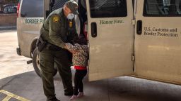 BROWNSVILLE, TEXAS - FEBRUARY 25: A U.S. Border Patrol agent releases a young asylum seeker with her family at a bus station on February 25, 2021 in Brownsville, Texas. U.S. immigration authorities are now releasing asylum seeking families after they cross the U.S.-Mexico border and taken into custody. The immigrant families are then free to travel to destinations throughout the U.S. while awaiting asylum hearings.  (Photo by John Moore/Getty Images)