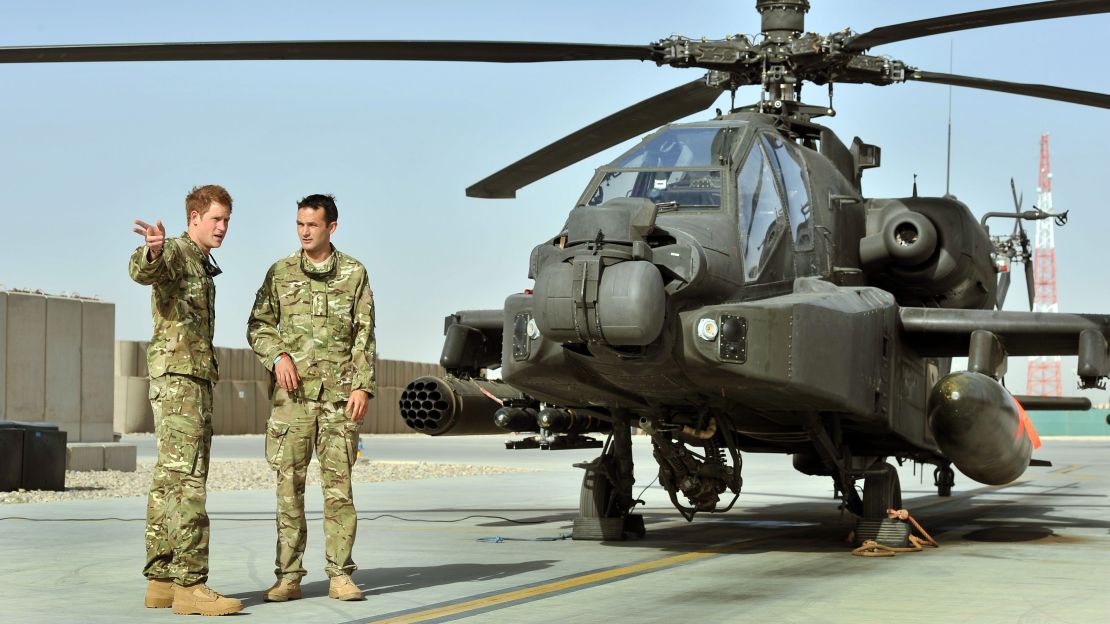 Prince Harry (left) was shown the Apache flight line by a member of his squadron at Camp Bastion in 2012 in Helmand province, Afghanistan.