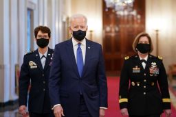 US President Joe Biden arrives, flanked by the nominees to positions as 4-star Combatant Commanders Gen. Jacqueline Van Ovost (L) and Lt. Gen. Laura Richardson, on March 8, 2021. 
