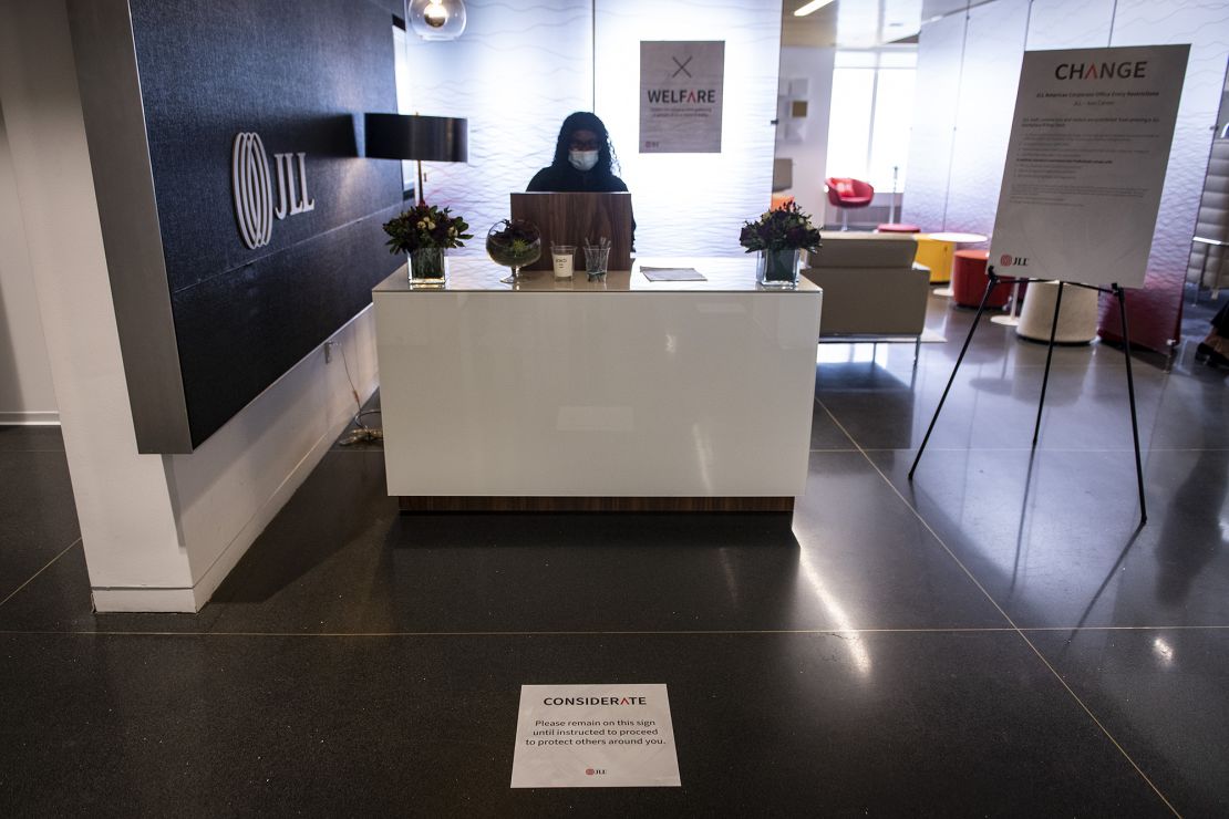 A social distancing marker is displayed in front of a reception desk at the JLL office in Chicago.