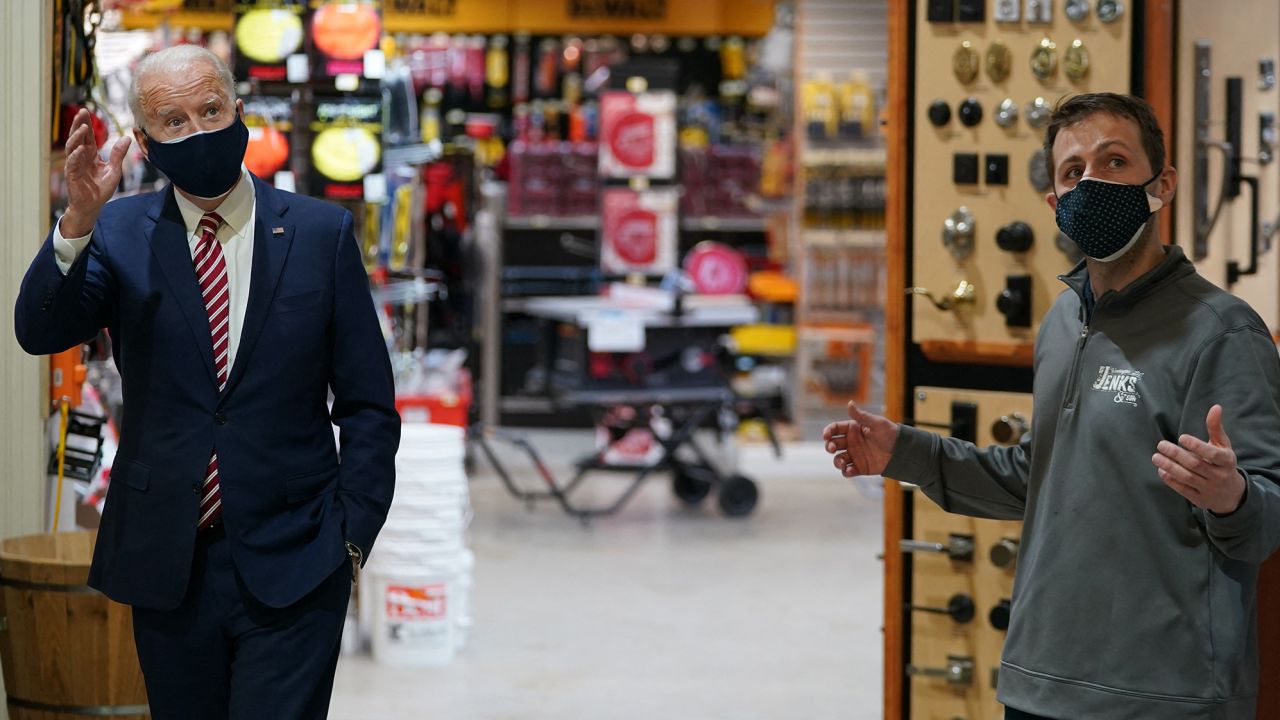 US President Joe Biden (L) visits W.S. Jenks & Son, a hardware store that has benefited from a Paycheck Protection Program (PPP) loan, in Washington, DC, on March 9, 2021. - Biden met with Michael Siegel (R), co-owner of W.S. Jenks & Son, and Mary Anna Ackley, owner of Little Wild Things Farm, a business next door to Jenks & Son which also benefited from the PPP. (Photo by Mandel Ngan/AFP/Getty Images)