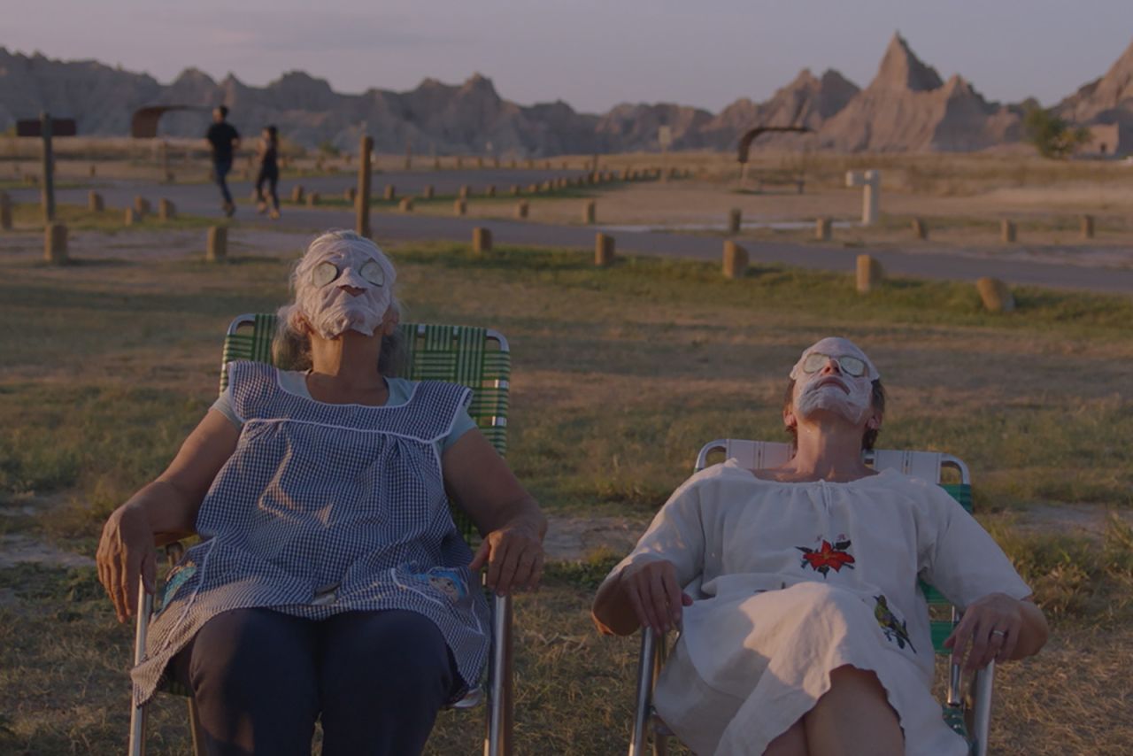 Linda May and Fern (Frances McDormand) recreate a spa experience between shifts at a camp site in "Nomadland."