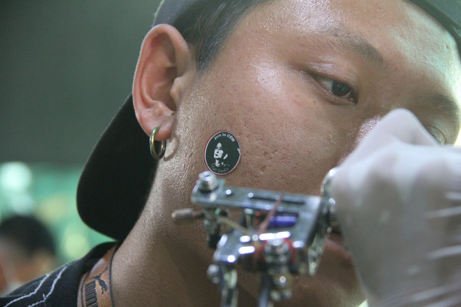 A tattooist at work during the event on March 5, 2021. 