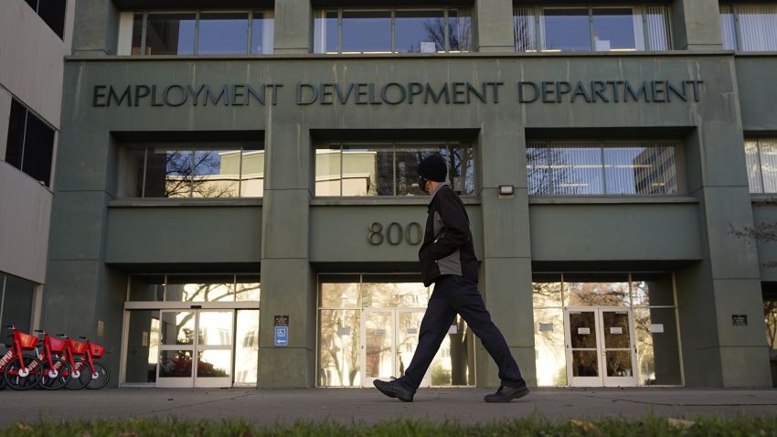 FILE - In this Dec. 18, 2020, file photo, a person passes the office of the California Employment Development Department in Sacramento, Calif. Some Americans are receiving tax forms saying they owe money on unemployment benefits they never received. The notices from state governments could be a sign of the extent of identity theft in the nation's state-run unemployment systems. Unemployment benefits are taxable, so government agencies must send a tax form to people who received them. (AP Photo/Rich Pedroncelli, File)
