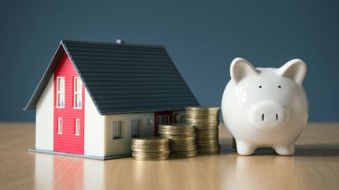 underscored mortgage house money and piggy bank