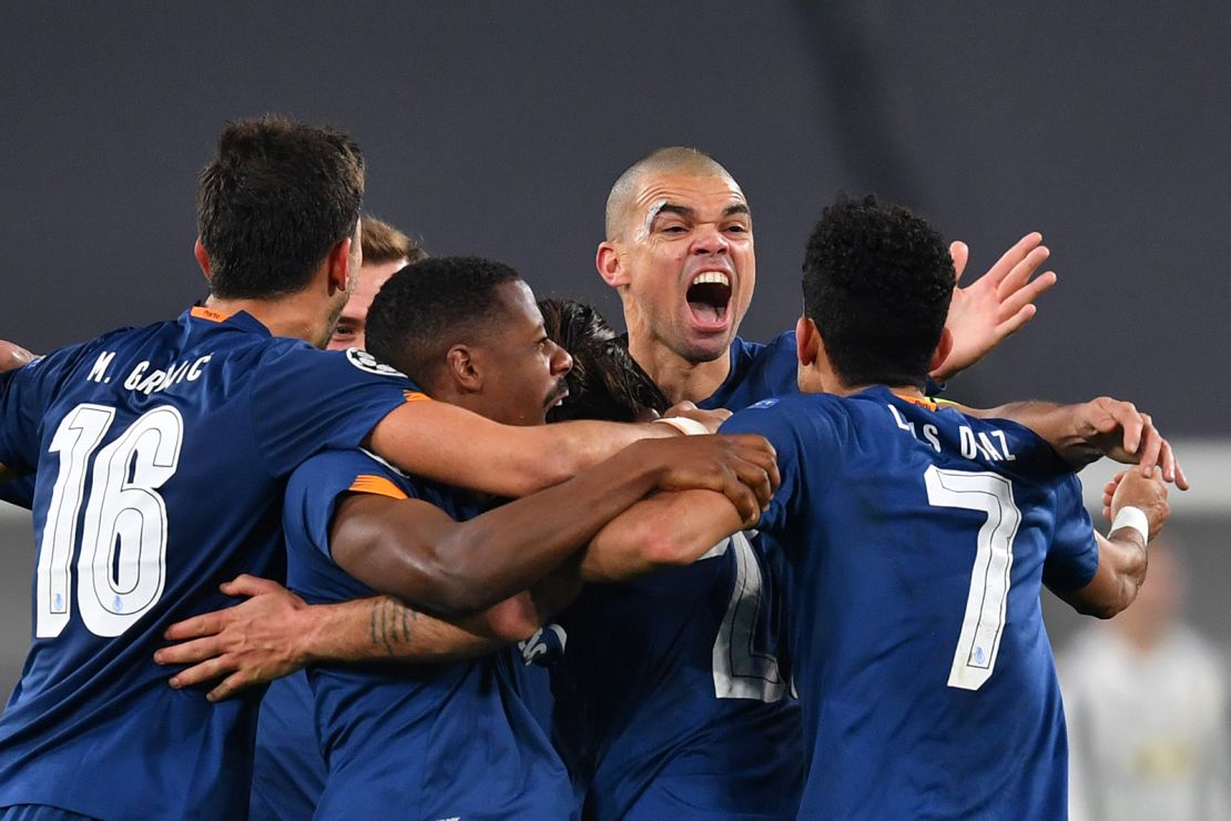 Oliveira celebrates with teammates after scoring their side's second goal against Juventus.