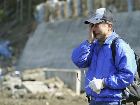 A man cries as he searches for his son, who was a teacher at Okawa Elementary School in Ishinomaki, Miyagi prefecture. The school was devastated by the earthquake and tsunami on March 11. 