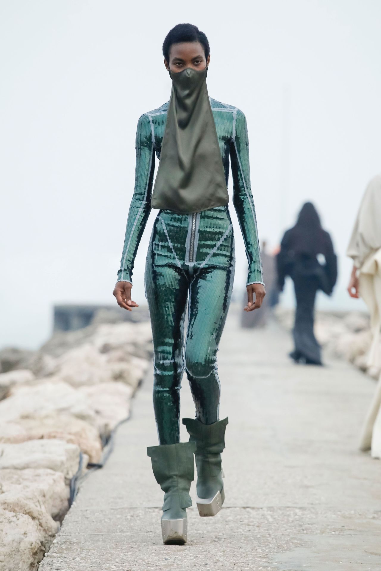 Rick Owens' latest collection featured enormous structured outerwear, masked models and slick, sequin bodysuits.<br />