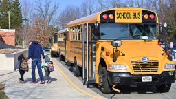 ARLINGTON, VA - MARCH 04: A school bus arrives at Ashlawn elementary school on March 4, 2021 in Arlington, VA. Ashlawn elementary school reopens on Thursday in Arlington. (Photo by Chen Mengtong/China News Service via Getty Images)