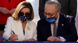 House Speaker Nancy Pelosi of Calif., signs the $1.9 trillion COVID-19 relief bill, accompanied by Senate Majority Leader Chuck Schumer of N.Y., during an enrollment ceremony on Capitol Hill, Wednesday, March 10, 2021, in Washington. (AP Photo/Alex Brandon)