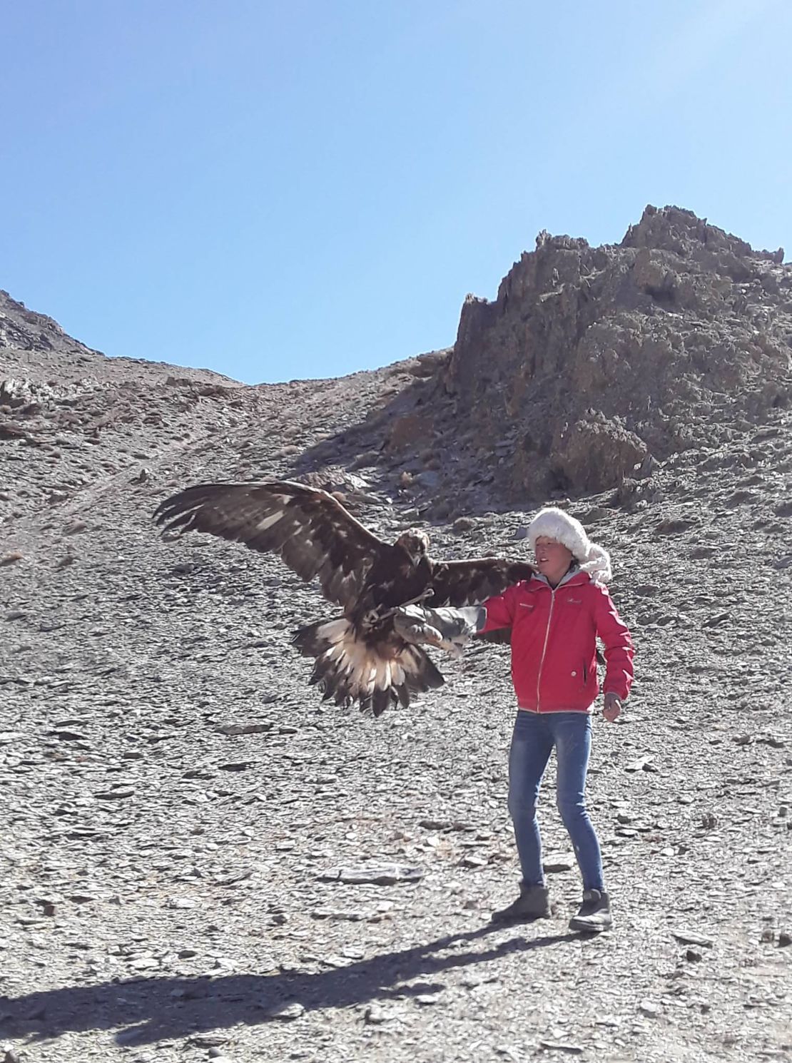 Sattigul, a 16-year-old from Mongolia, was born into a family of nomadic herders who move four times a year. She is pictured with her eagle, Akhyikh, who she writes "always gives me courage and energy."