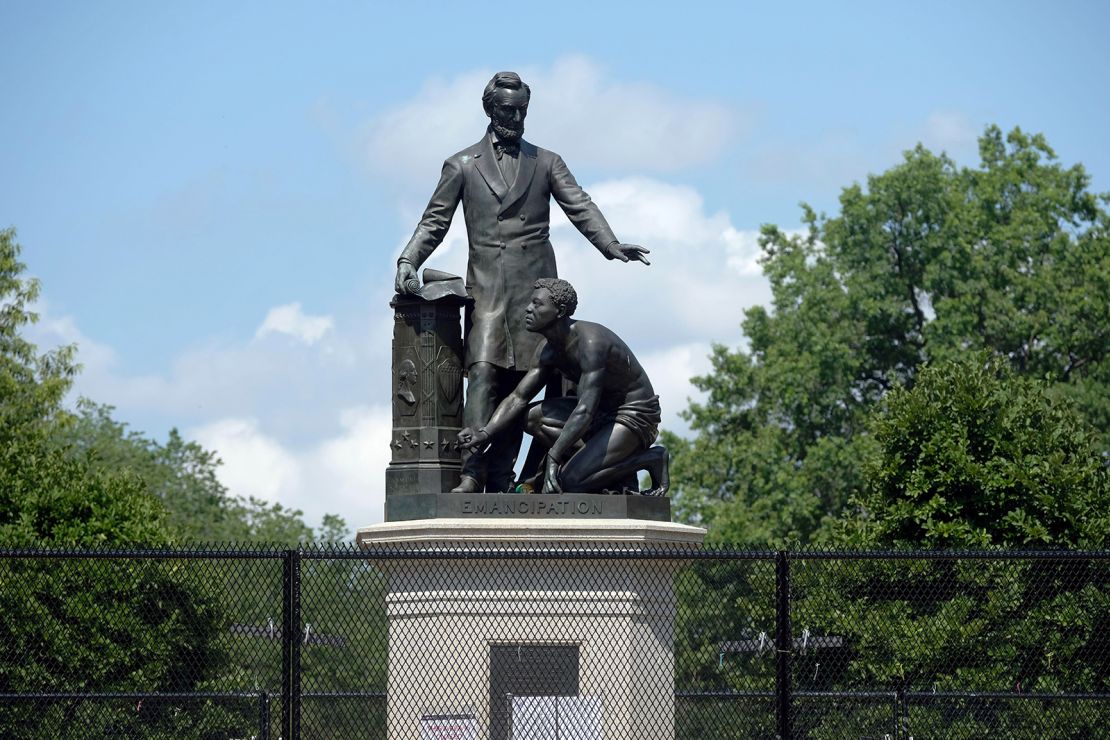 The controversial Emancipation Memorial on Capitol Hill in Washington. Some say its depiction of Lincoln looming over a slave is demeaning. The statue is protected by a fence to keep out protesters.