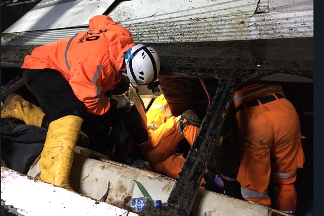 Rescuers search for survivors inside the bus wreckage in Sumedang West Java, Indonesia, on March 11.