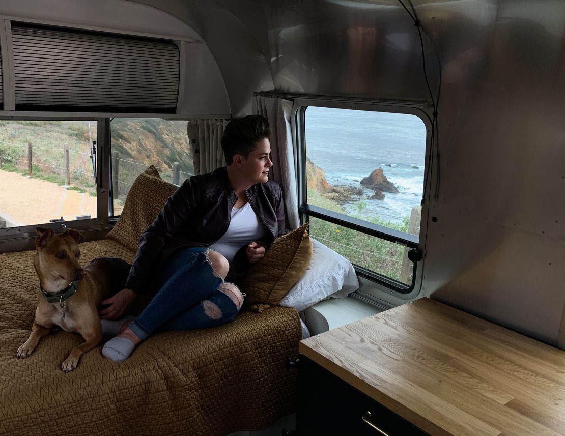 Nicole Maddox sits with her dog, Stanley, in her Airstream trailer in Rancho Palos Verdes, California. Maddox retrofitted the trailer so she is able to work remotely from anywhere in the country.