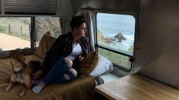 Nicole Maddox sit with her dog Stanley in her airstream trailer in Rancho Palos Verdes, California, on Sunday, March 7. Maddox retrofitted the trailer to add a work space so she is able to work remotely from anywhere in the country.