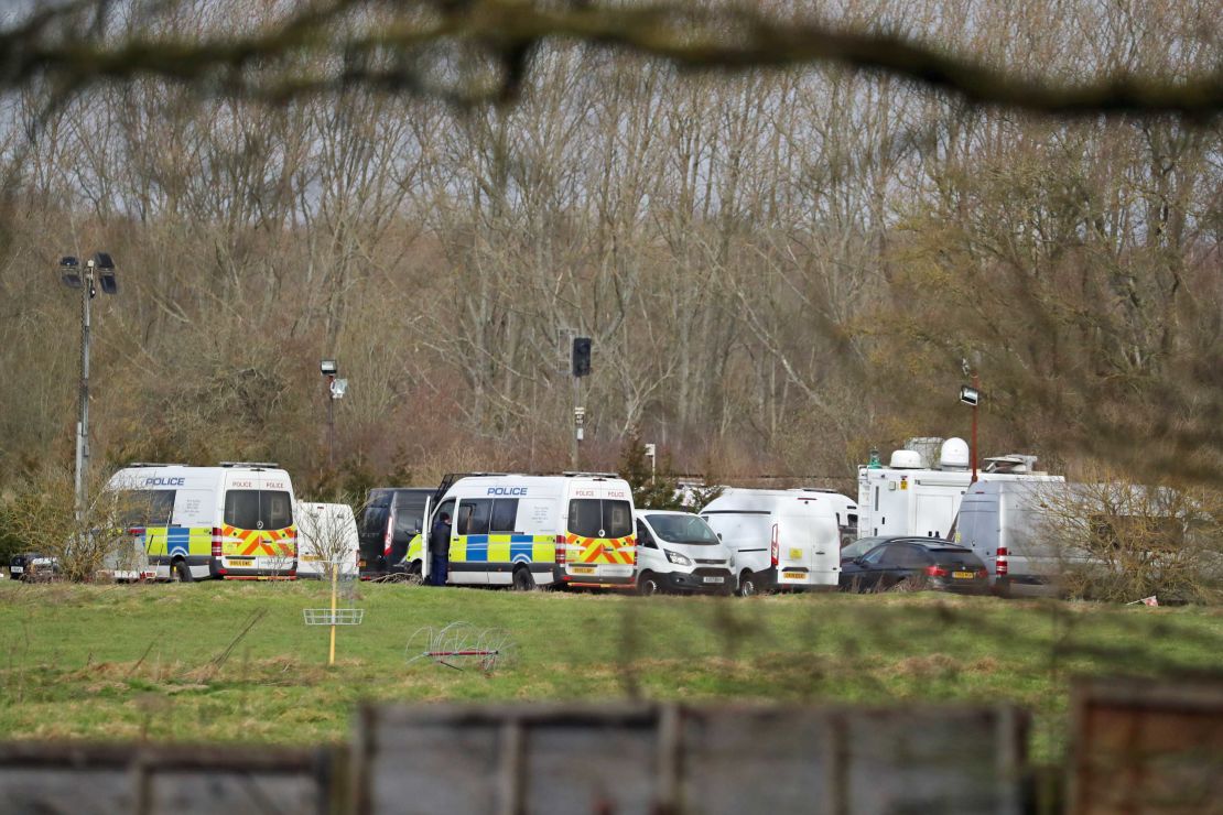 Police vehicles parked Thursday near Ashford in Kent following the discovery of human remains in the hunt for missing Sarah Everard.