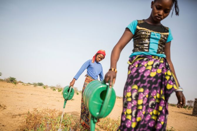 In Senegal, Penda Diery Ba, 13, and Hawa Ka, 12, water a community garden as part of the "Nanandiral Antent Koyly" (Women's Association of Koyly).