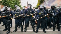 Law enforcement hold a line as a man is being detained during a demonstration on September 25, 2020 in Louisville, Kentucky.