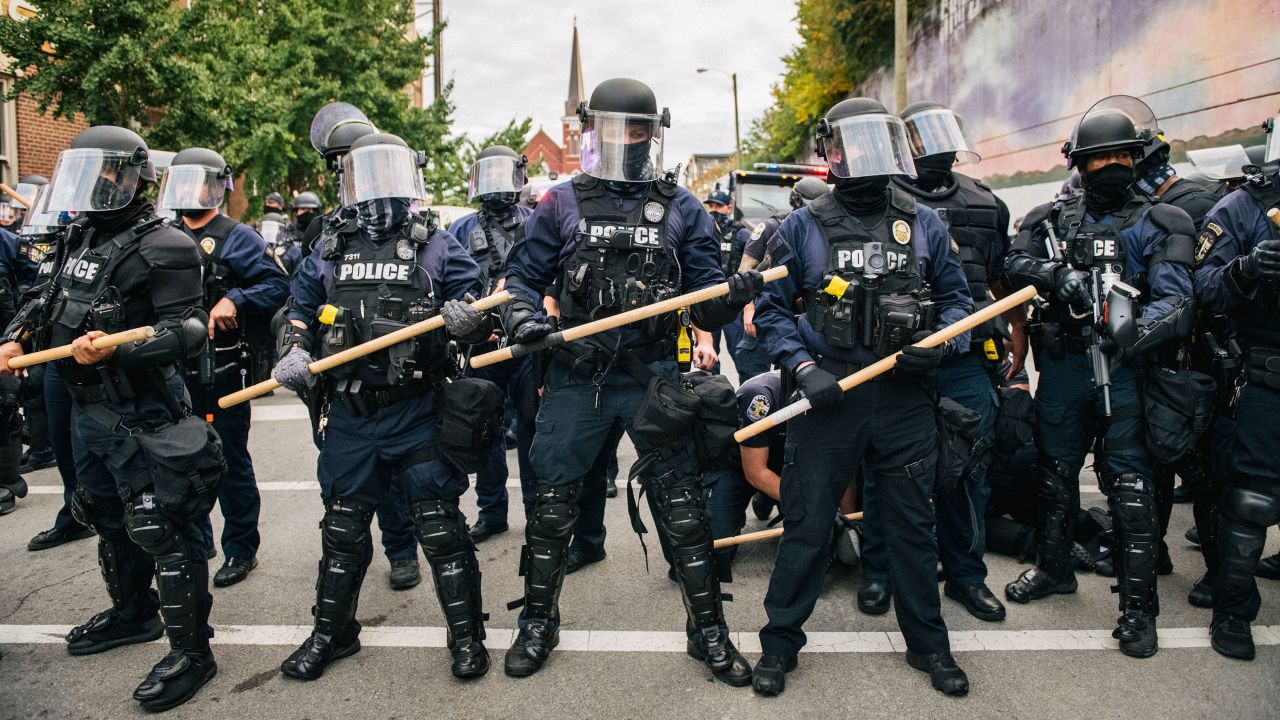 Law enforcement hold a line as a man is being detained during a demonstration on September 25, 2020 in Louisville, Kentucky. 