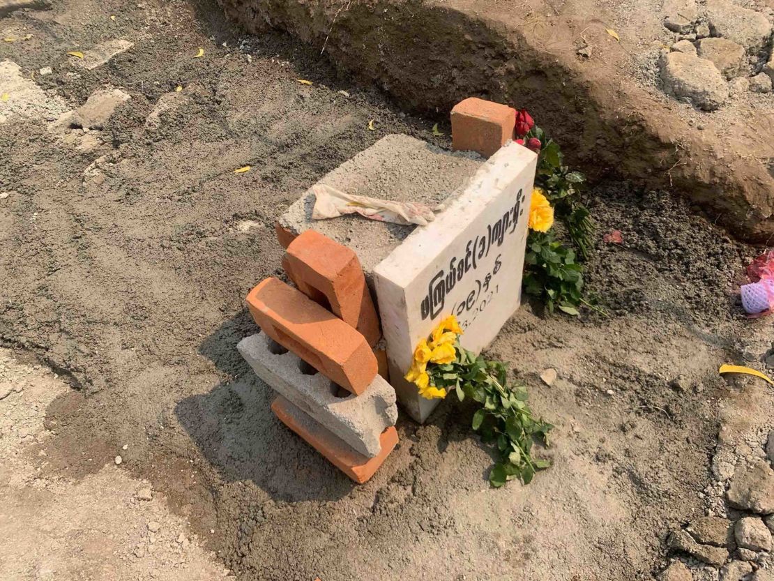 A glove is seen on the freshly-cemented grave of 19-year-old protester, Angel, also known as Ma Kyal Sin, on March 6, in Mandalay, Myanmar, after authorities exhumed her body.