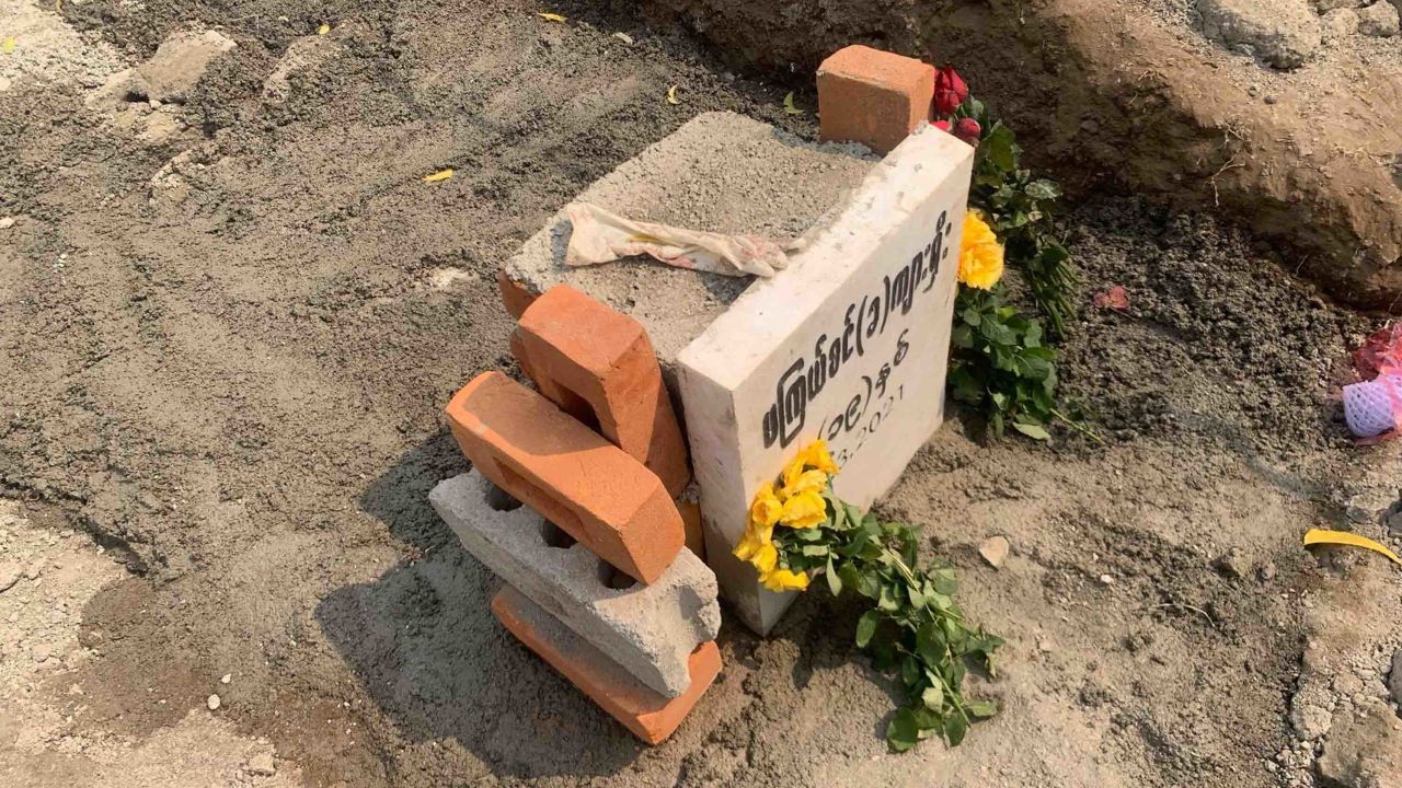 A glove is seen on the freshly-cemented grave of 19-year-old protester, Angel, also known as Ma Kyal Sin, on March 6, in Mandalay, Myanmar, after authorities exhumed her body.