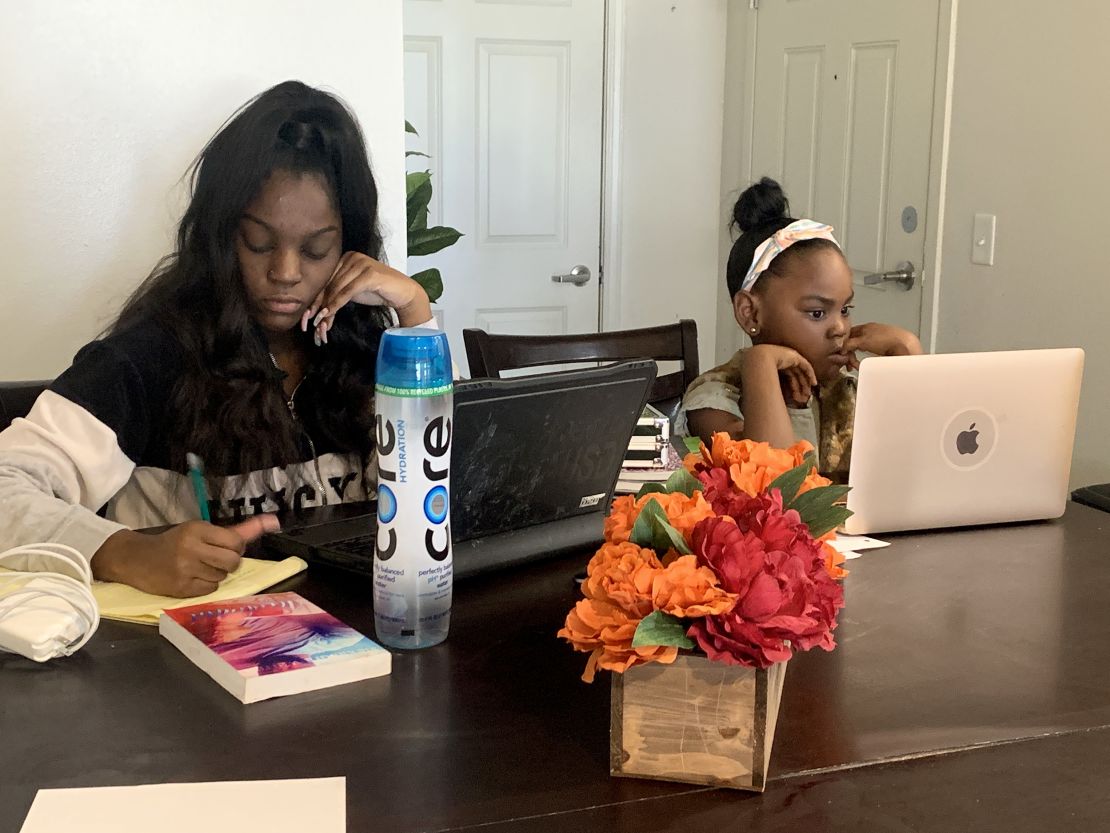 Keilah Corbin, left, and her little sister Carson attend classes online.