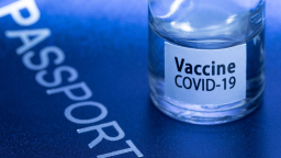 A picture taken on March 3, 2021 in Paris shows a vaccine vial reading "Covid-19 vaccine" on an European passport. (Photo by JOEL SAGET / AFP) (Photo by JOEL SAGET/AFP via Getty Images)