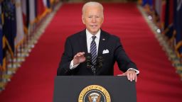 US President Joe Biden gestures as he speaks on the anniversary of the start of the Covid-19 pandemic, in the East Room of the White House in Washington, DC on March 11, 2021.