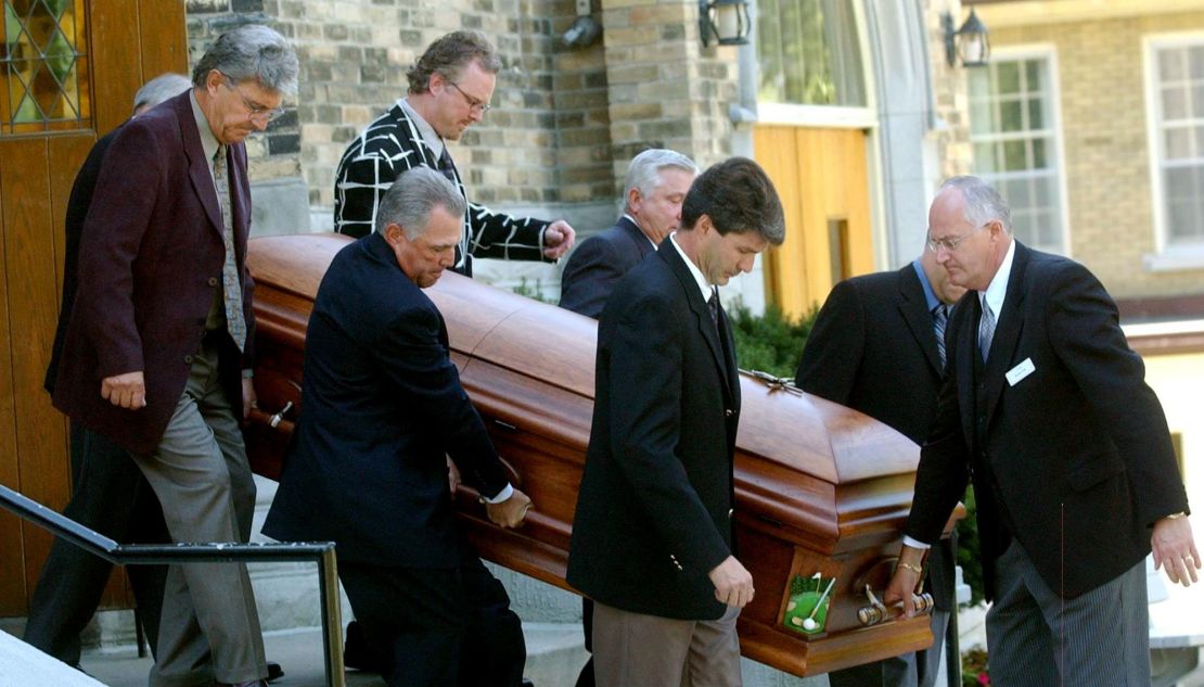 Pallbearers acccompany the coffin of Canadian golf legend Norman.