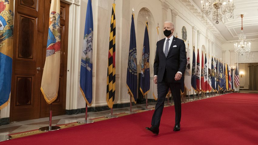 U.S. President Joe Biden wears a protective mask while arriving to deliver an address to the nation in the East Room of the White House in Washington, D.C., U.S., on Thursday, March 11, 2021. Biden is addressing a pandemic-weary nation to mark the day a year ago when the spread of coronavirus forced Americans into isolation, swiftly collapsing the economy and portending more than a half-million deaths. Photographer: Chris Kleponis/CNP/Bloomberg via Getty Images