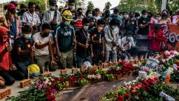 YANGON, MYANMAR - MARCH 11: People pay tribute by laying flowers and lighting candles next to dried blood at the spot where Chit Min Thu, 25, was killed in clashes on March 11, 2021 in Yangon, Myanmar. Myanmar's military Junta charged deposed de-facto leader Aung San Suu Kyi with accepting bribes and taking illegal payments in gold, as it also continued a brutal crackdown on a nationwide civil disobedience movement in which thousands of people have turned out in continued defiance of tear gas, rubber bullets and live ammunition. (Photo by Stringer/Getty Images)