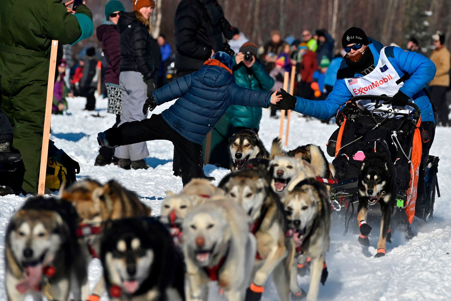 Seavey leans over for a high-five at the start of the race.