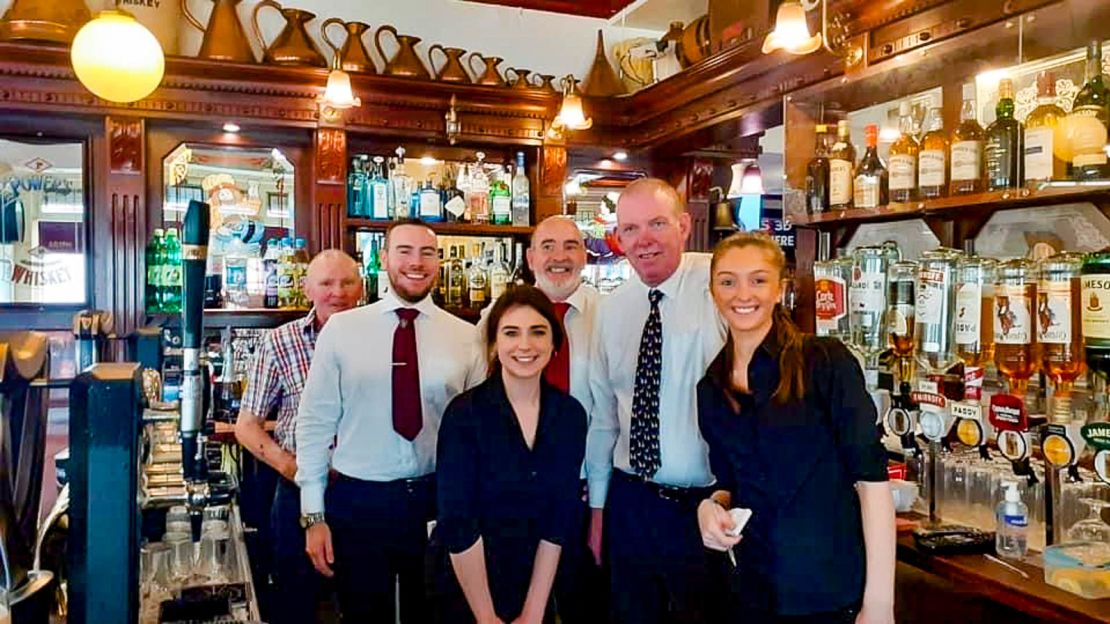 Owner of Dublin's Goose Tavern, Niall Newman, left, poses with his family and staff.