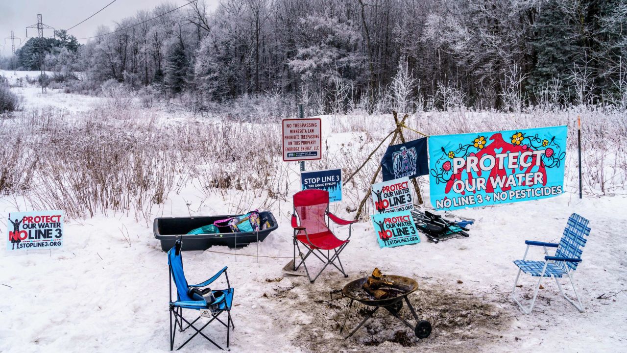 An anti-trespass notice is surrounded by signs protesting the construction on the Enbridge Line 3 crude oil pipeline.