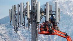 A contract crew for Verizon, works on a cell tower to update it to handle the new 5G network in Orem, Utah on December 10,  2019. - The new 5G cellular network will substantially increase cellular network speeds, opening up new markets for business and individuals. (Photo by GEORGE FREY / AFP) (Photo by GEORGE FREY/AFP via Getty Images)
