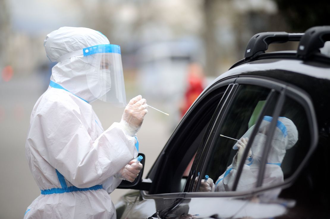 An Italian Red Cross worker takes a swab sample at a drive-through Covid-19 testing station in Florence, Italy on Friday. 
