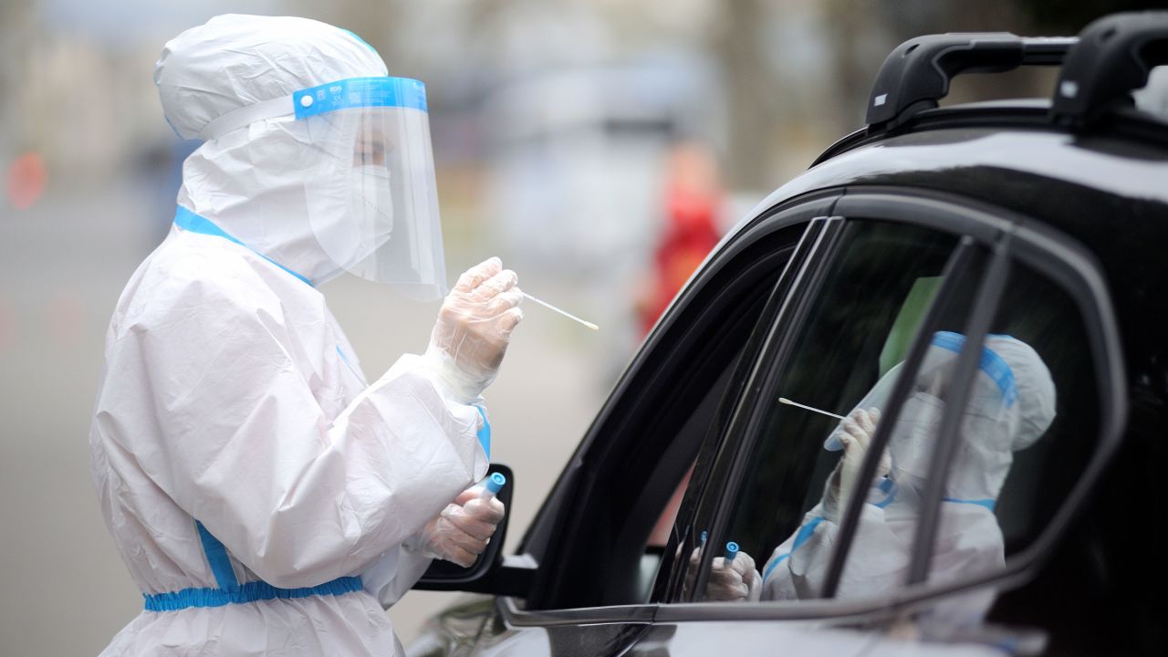 An Italian Red Cross worker takes a swab sample at a drive-through Covid-19 testing station in Florence, Italy on Friday.